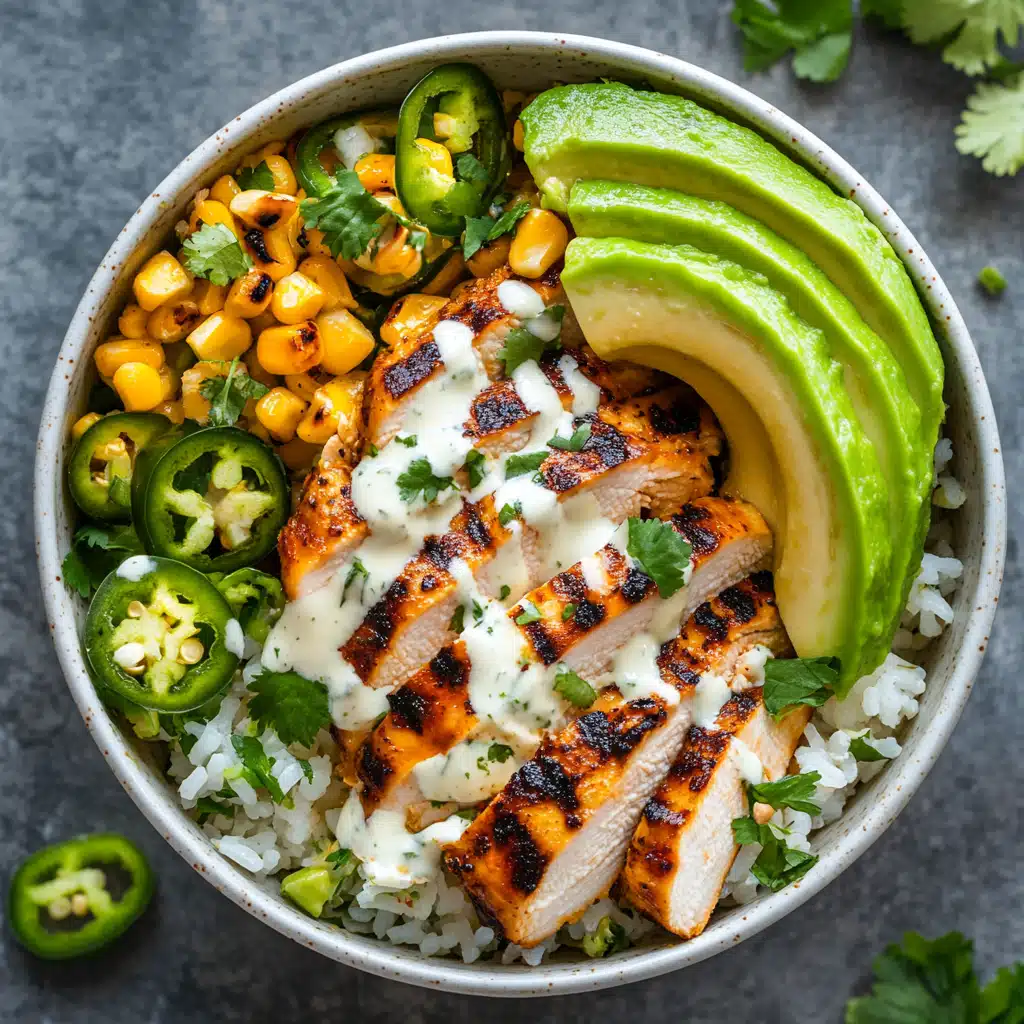 A top-down view of a Street Corn Chicken Rice Bowl being assembled with grilled chicken, creamy corn, and fresh toppings.